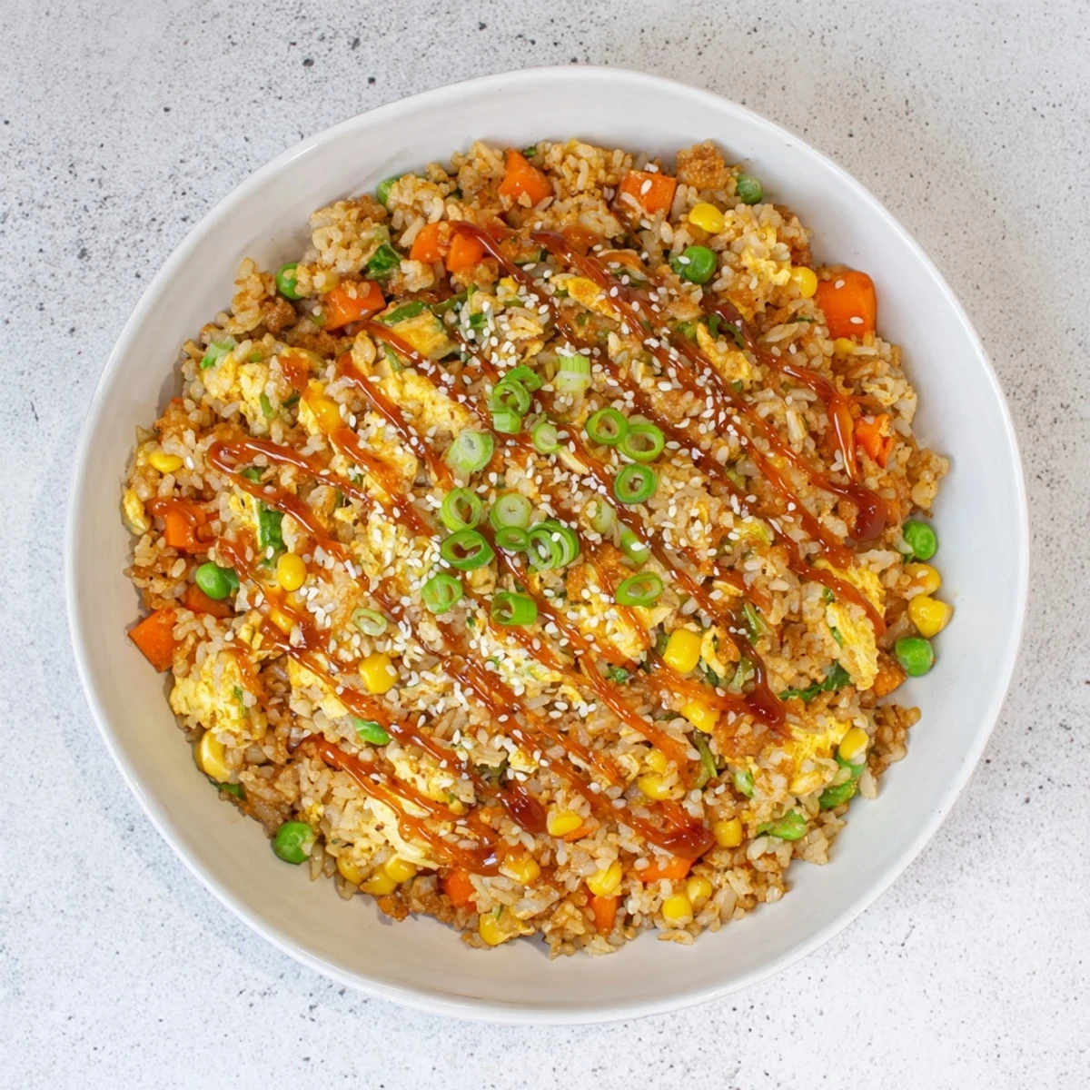 Savory frozen veggie fried rice with soy sauce glaze, topped with fresh green onions; a quick meal.