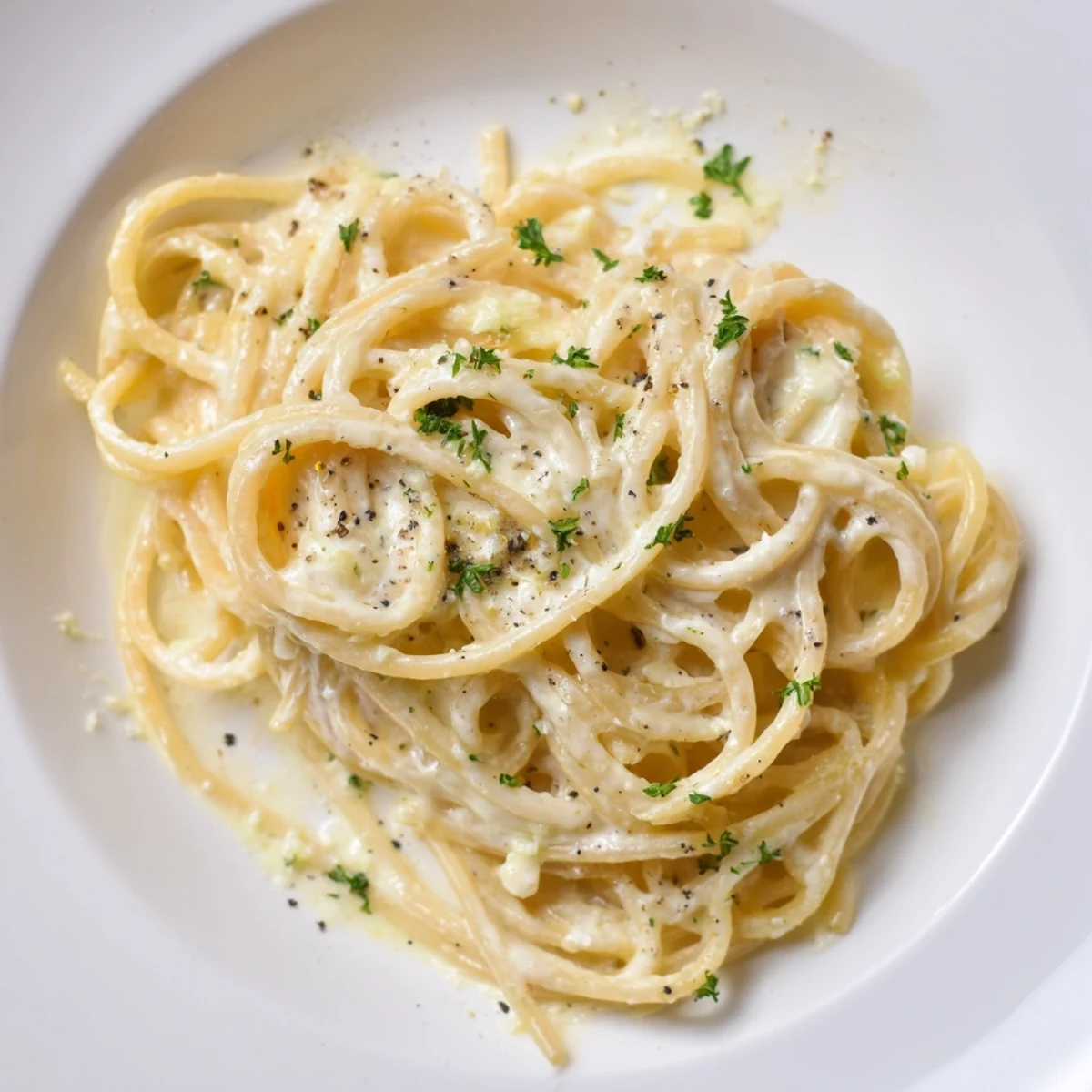 Delicious Creamy Three-Cheese Spaghetti, smelling amazing, with melted cheese and fresh parsley as a topping.