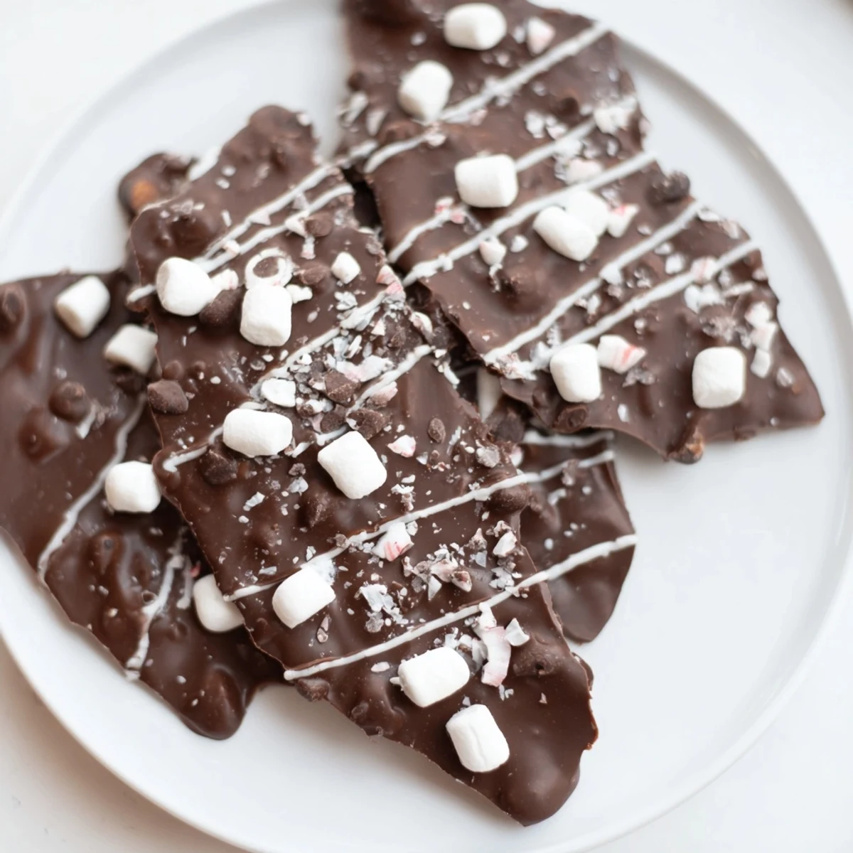 Rich, speckled Hot Chocolate Bomb Bark, showcasing a holiday dessert loaded with marshmallows and sprinkles.
