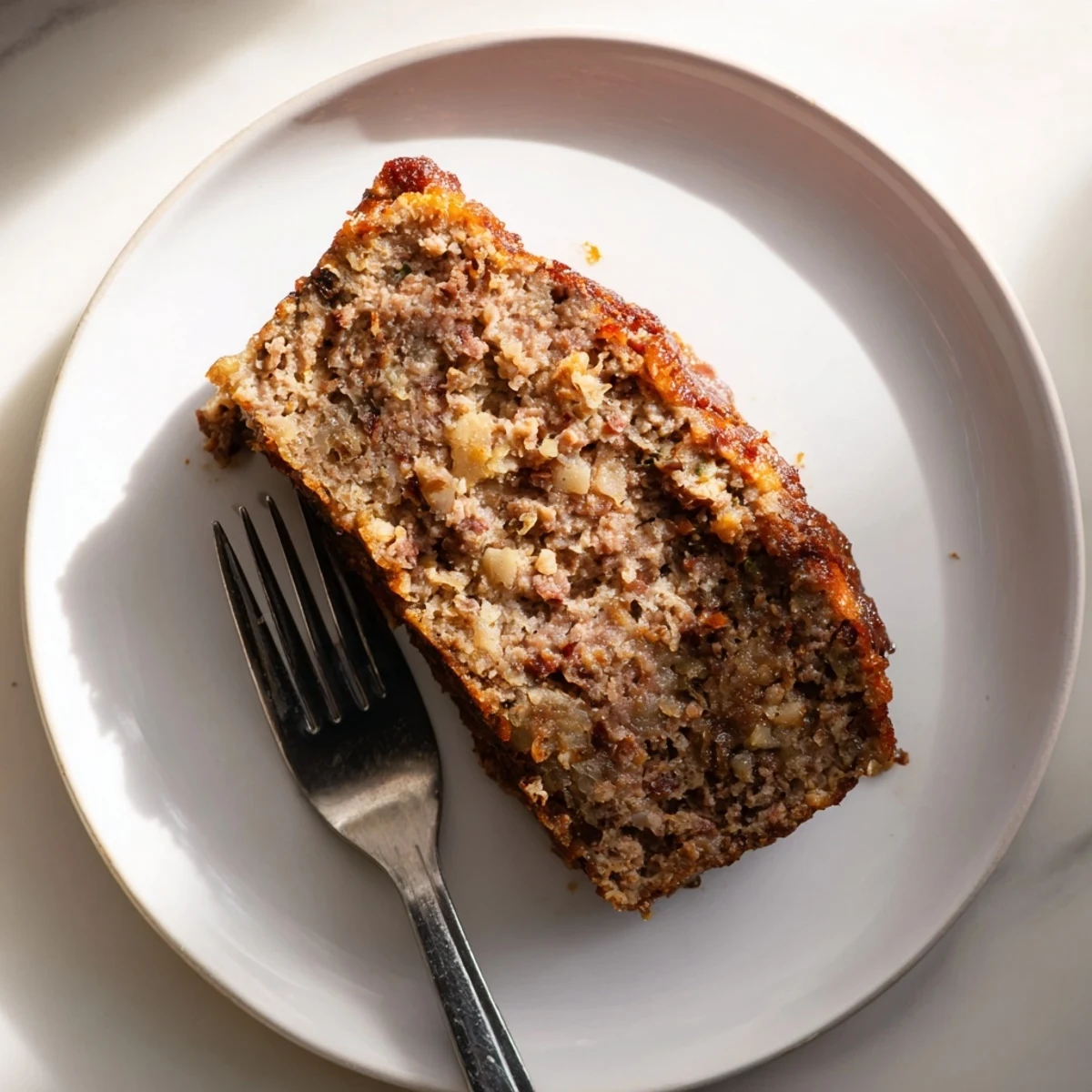 Golden-brown Effortless Stove Top Stuffing Meatloaf, ready to slice, offering savory, homemade flavors.