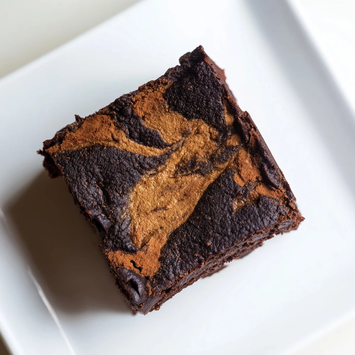 Warm and gooey Pumpkin Workout Brownies, perfect for a post-workout treat topped with Greek yogurt.