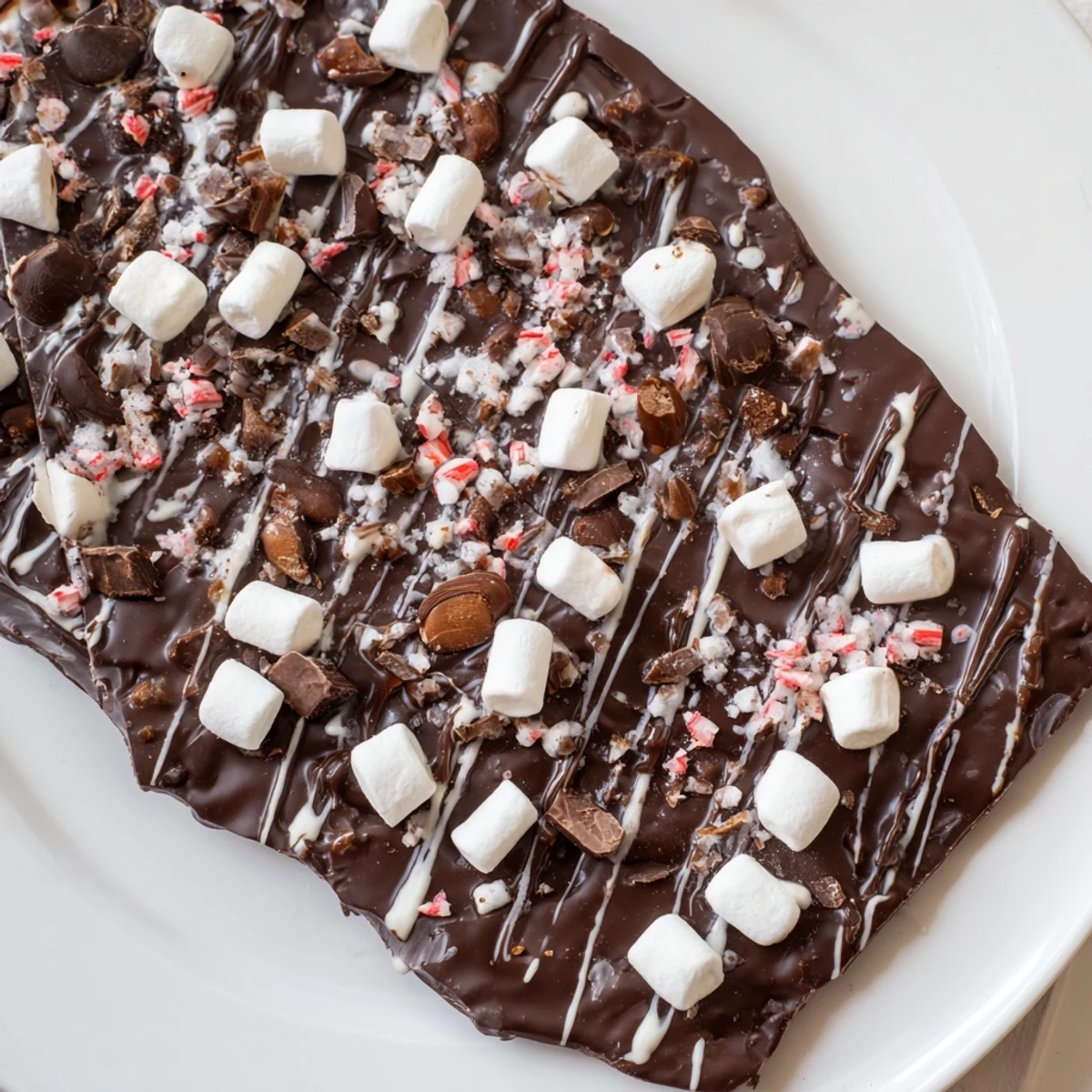 Dark chocolate Hot Chocolate Bomb Bark with marshmallows and cocoa mix, ready to break and enjoy.