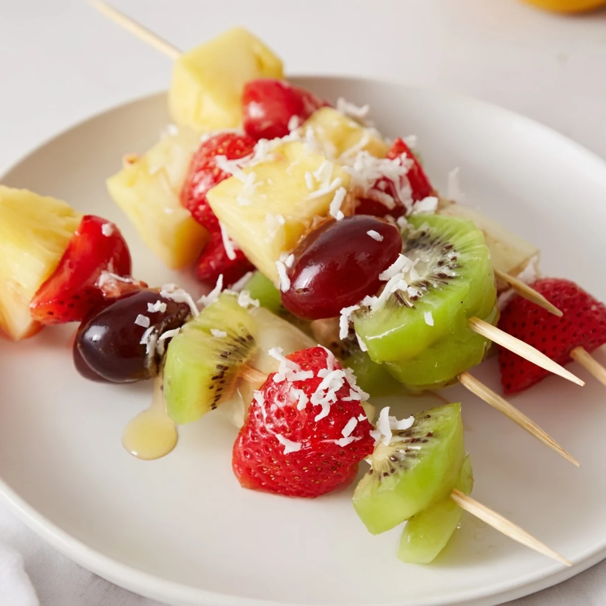 Vibrant, colorful Easy Festive Fruit Kabobs, perfect for a picnic, arranged beautifully on a platter.