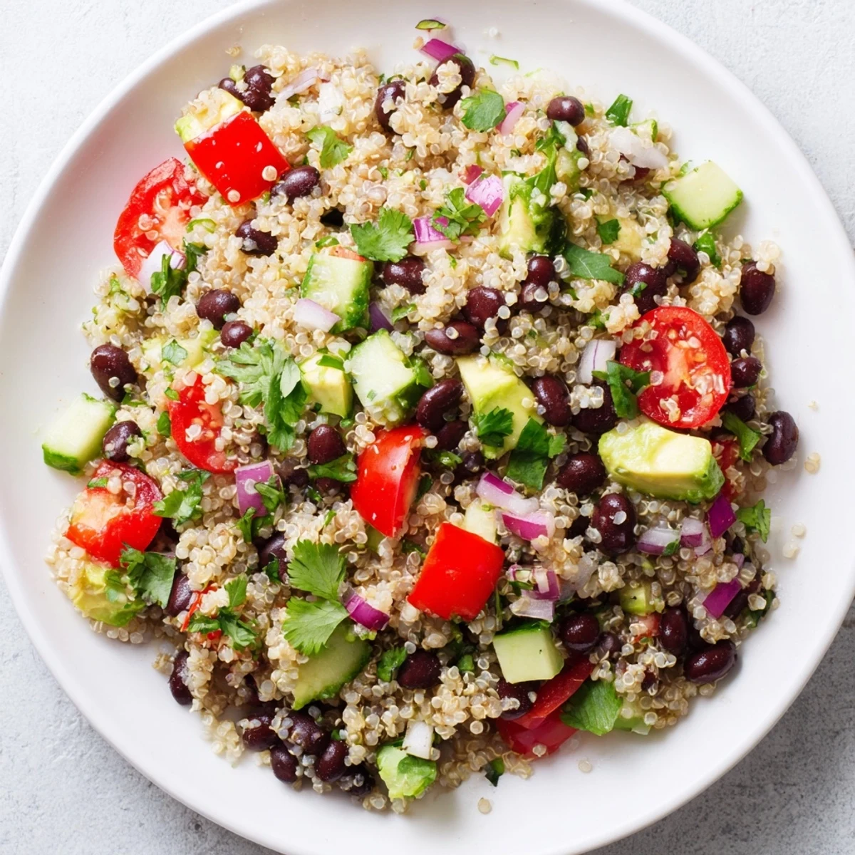 Cool and satisfying, this Quinoa Black Bean Salad features a bright lime dressing and fresh herbs.