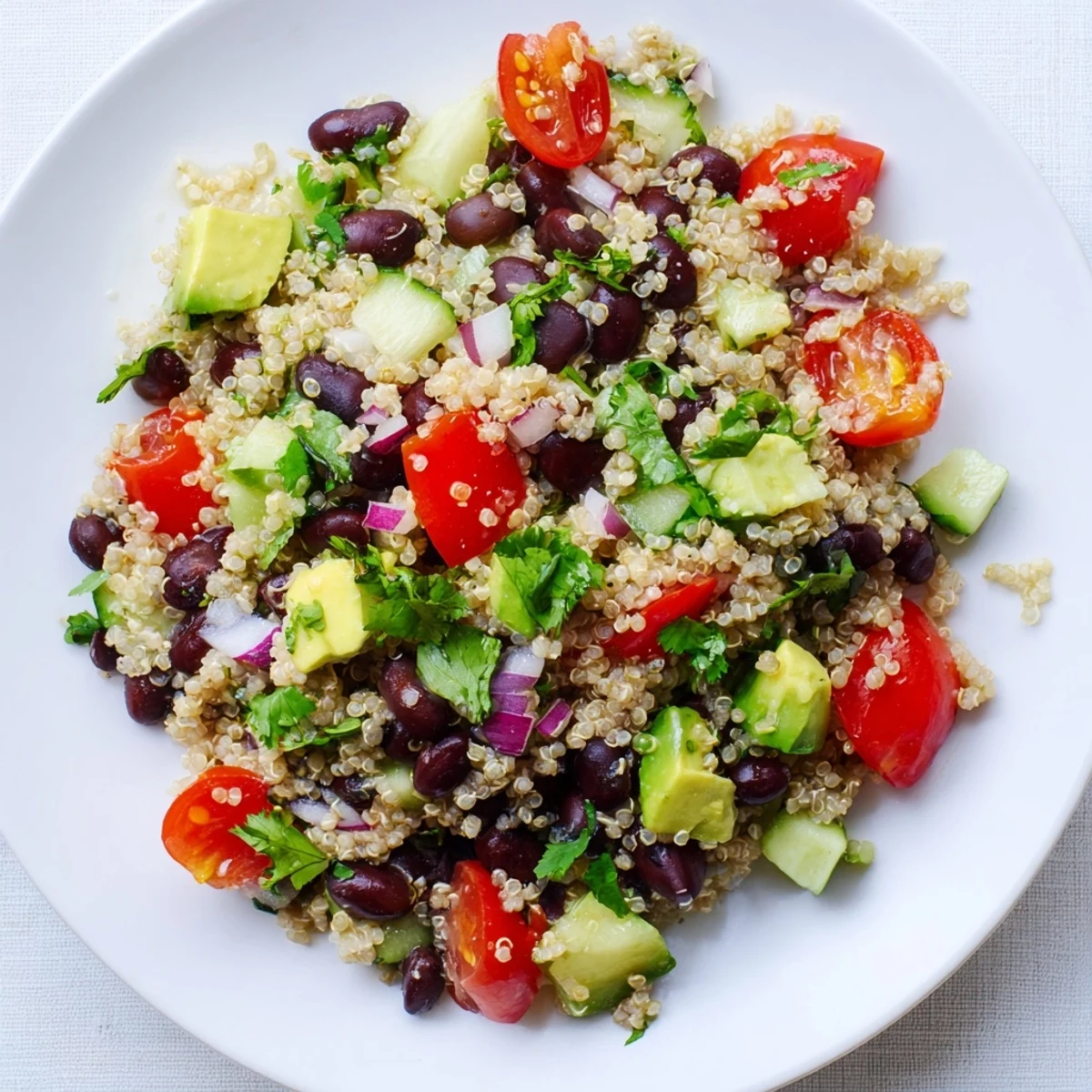 Vibrant Quinoa Black Bean Salad with diced avocado, perfect for a flavorful vegetarian lunch.