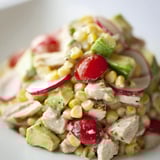 Hearty Roasted Corn & Chicken Chopped Salad with creamy avocado, radishes, and cherry tomatoes, drizzled with zesty lime dressing.  
