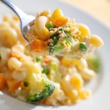 Steaming bowl of Garden Veg Mac and Cheese topped with crispy panko and fresh herbs on a rustic table.
