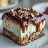 Decadent carrot cake cheesecake bars with creamy swirl and smooth frosting, perfect for spring gatherings or dessert parties.