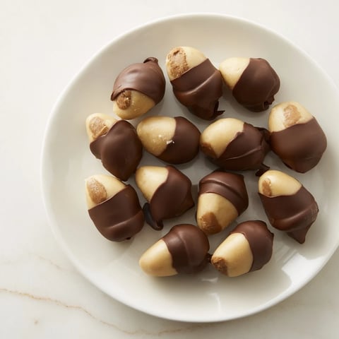 Creamy Peanut Butter Buckeyes dipped in dark chocolate, a homemade holiday delight.