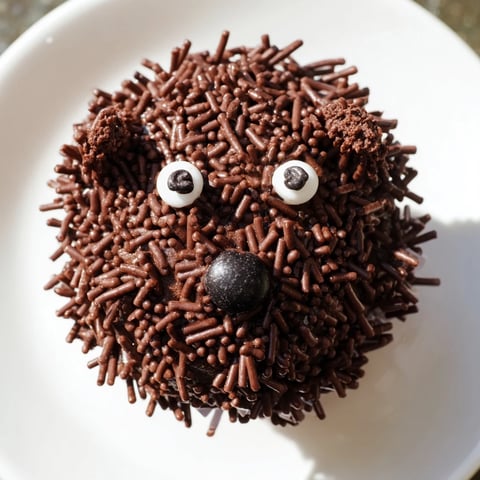 A delightful Hedgehog Cupcake Tower with fluffy chocolate frosting and chocolate sprinkle spikes looks amazing.