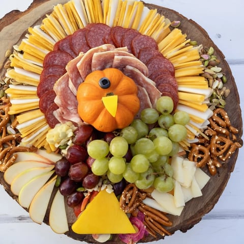 A beautifully arranged Wheat Field Thanksgiving Turkey Board loaded with cheese and cured meats for holiday feasting.