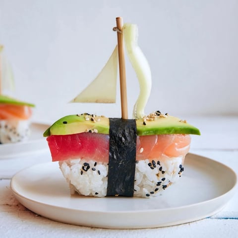 Freshly made Sushi Sailboats at Sea, featuring vibrant fish and veggie toppings, ready to enjoy.