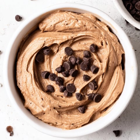 Creamy Brownie Batter Dip, swirled and ready to be scooped with fresh strawberries—a perfect dessert.