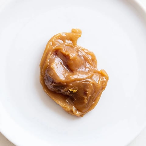 Creamy Emirati Al Madrooba with glistening ghee, served alongside warm bread for dipping.