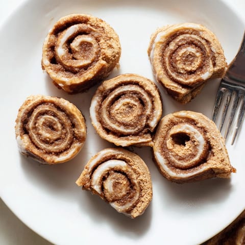 Warm, homemade Peanut Butter Cinnamon Roll Cookies filling a baking sheet, fragrant and inviting.