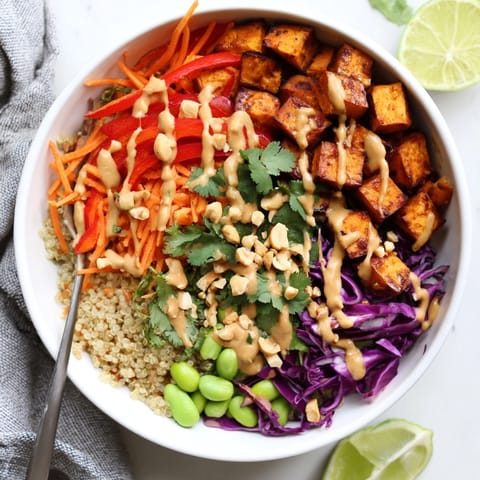 Creamy Thai Peanut Roasted Sweet Potato Bowl with quinoa, cabbage, and crunchy peanuts.