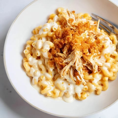 Golden, bubbly classic mac & cheese with tender BBQ chicken, perfect for family dinners.  
