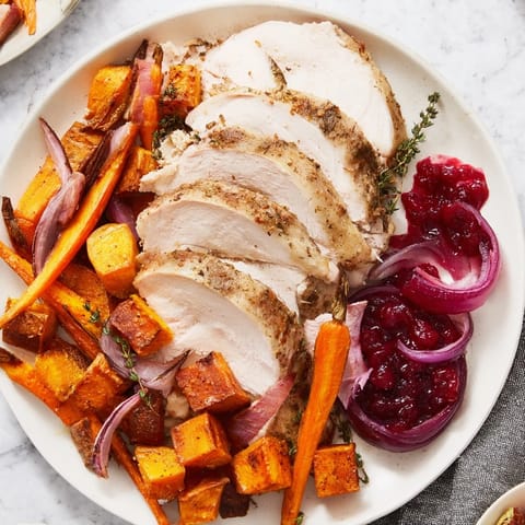 This delicious image shows a colorful Harvest Turkey Platter served with a vibrant cranberry-orange sauce.