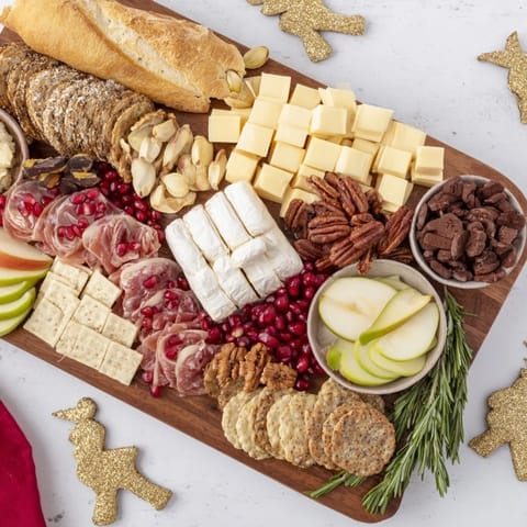 Arranged Twelve Days of Christmas Snack Board featuring colorful treats like grapes and figs, perfect for holiday entertaining.