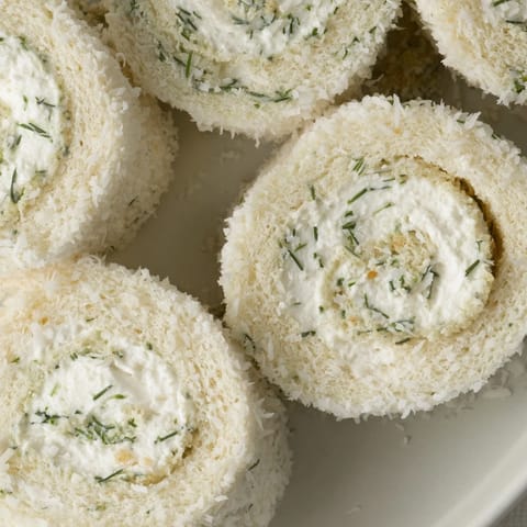 Delicious, creamy Snowball Tea Sandwich Bites rolled in sweet coconut, perfect for a party appetizer.