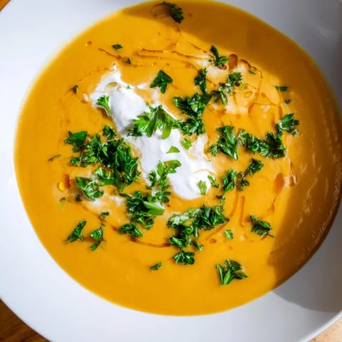 A steaming bowl of flavorful Sweet Maple Carrot Soup, ready to be enjoyed on a chilly evening.