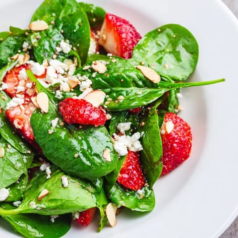 Fresh, vibrant Strawberry Spinach Salad featuring sweet strawberries and toasted almonds with tangy dressing.