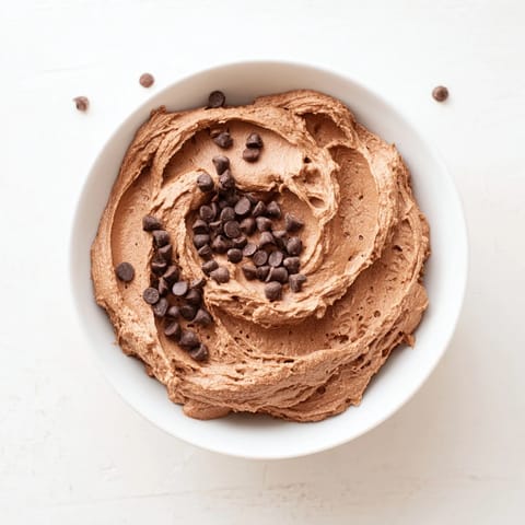 Thick, gluten-free Brownie Batter Dip, dotted with chocolate chips, is ideally served with gluten-free pretzels.