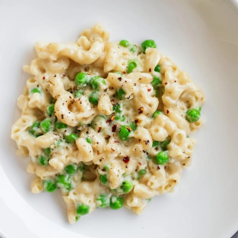 Close-up of macaroni & peas, showing the tender pasta and sweet peas, perfect for dinner.