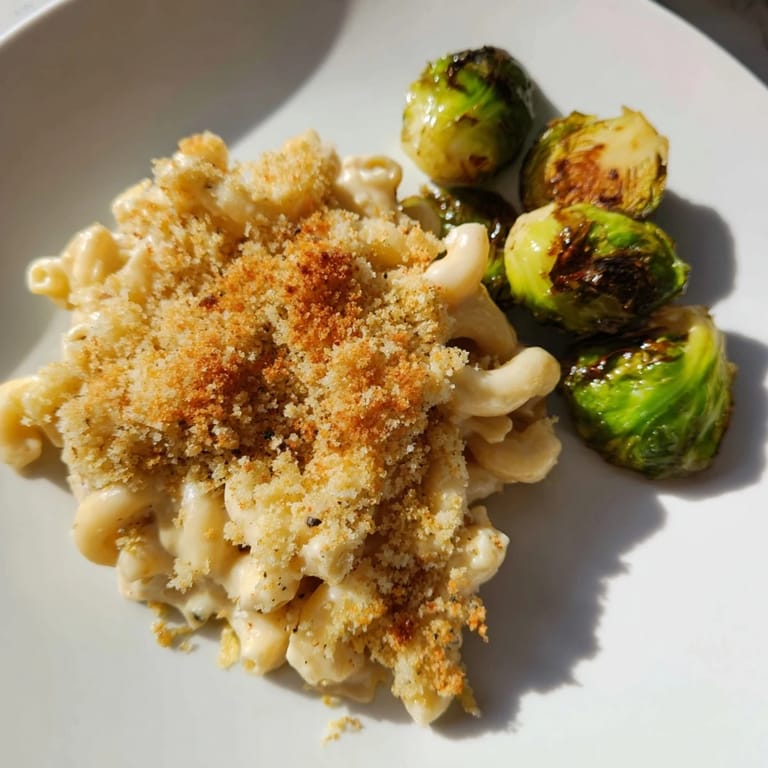 This Sheet Pan Mac and Cheese with Brussels Sprouts features crispy golden topping and tender macaroni amidst savory cheese.