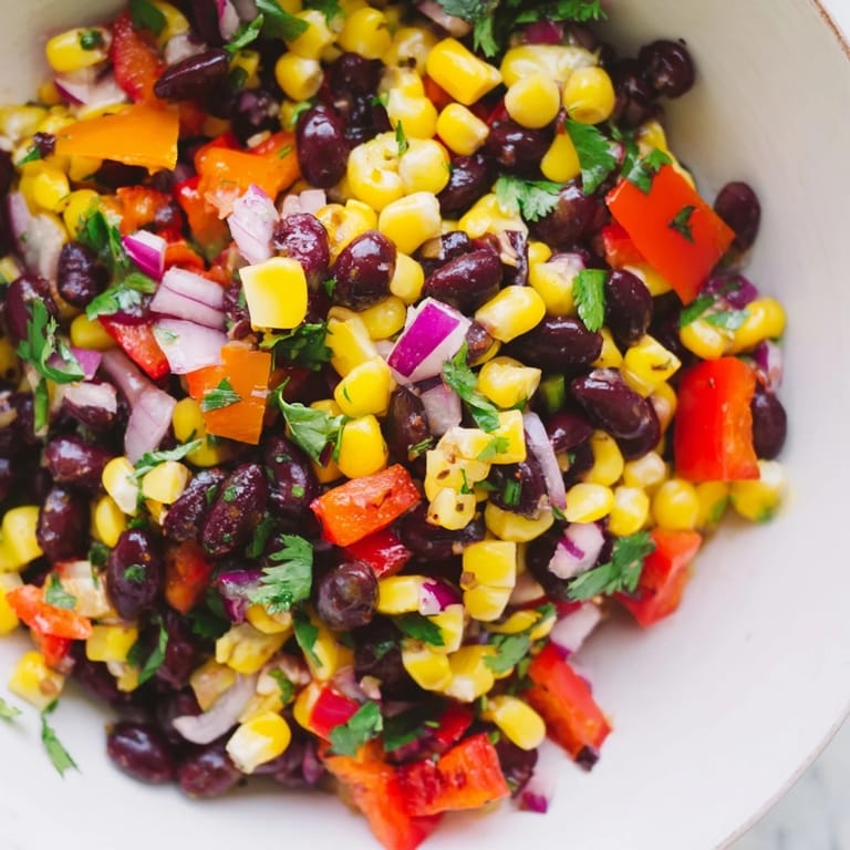 This vibrant Southwest Black Bean Salad features sweet corn, peppers, and a zesty lime dressing.