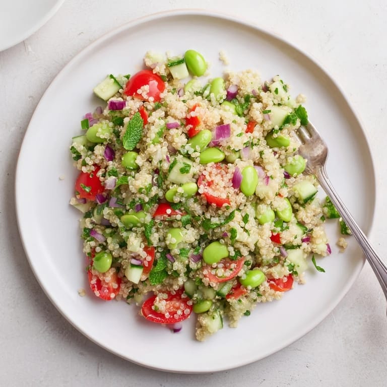 Colorful Edamame and Quinoa Salad in a white bowl, ready to serve alongside grilled chicken or as a vegetarian main.