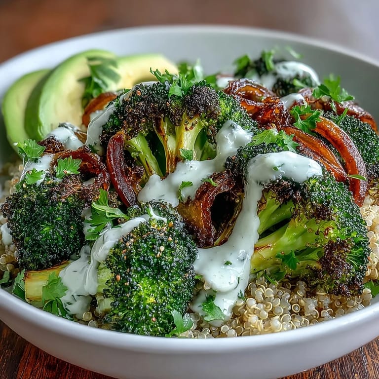 Roasted Broccoli Bowl garnished with fresh parsley, sesame seeds, and lemon wedges on a rustic table.