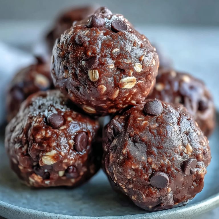 A close-up of no-bake Vegan Chocolate Peanut Butter Protein Balls ready to snack on after a workout.