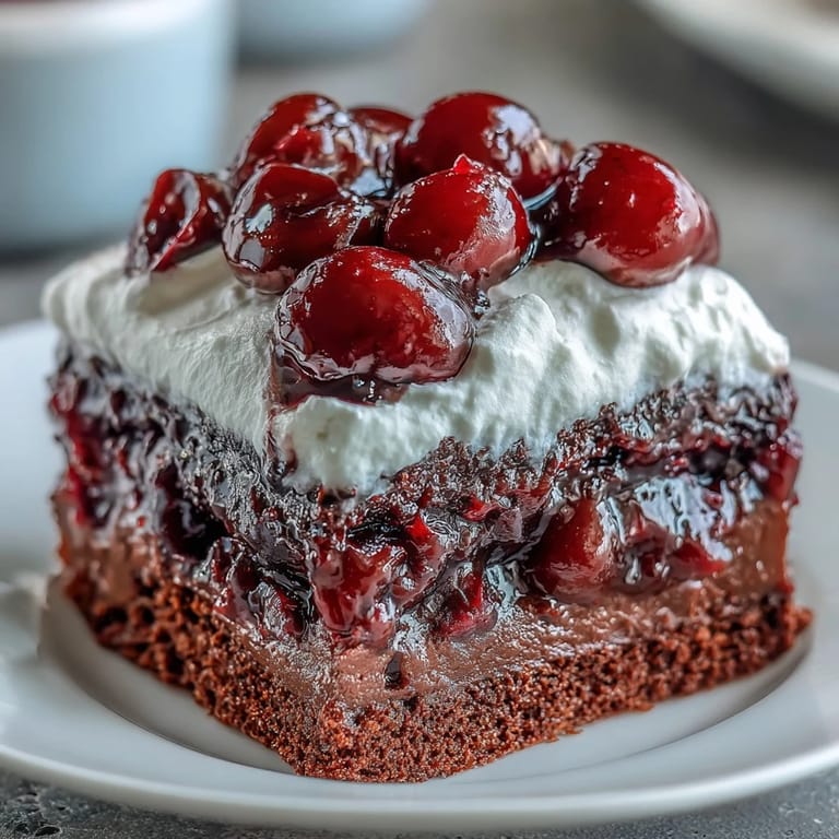 Refreshing Cherry Cola Jello Poke Cake with deep red gelatin soaking into cake.